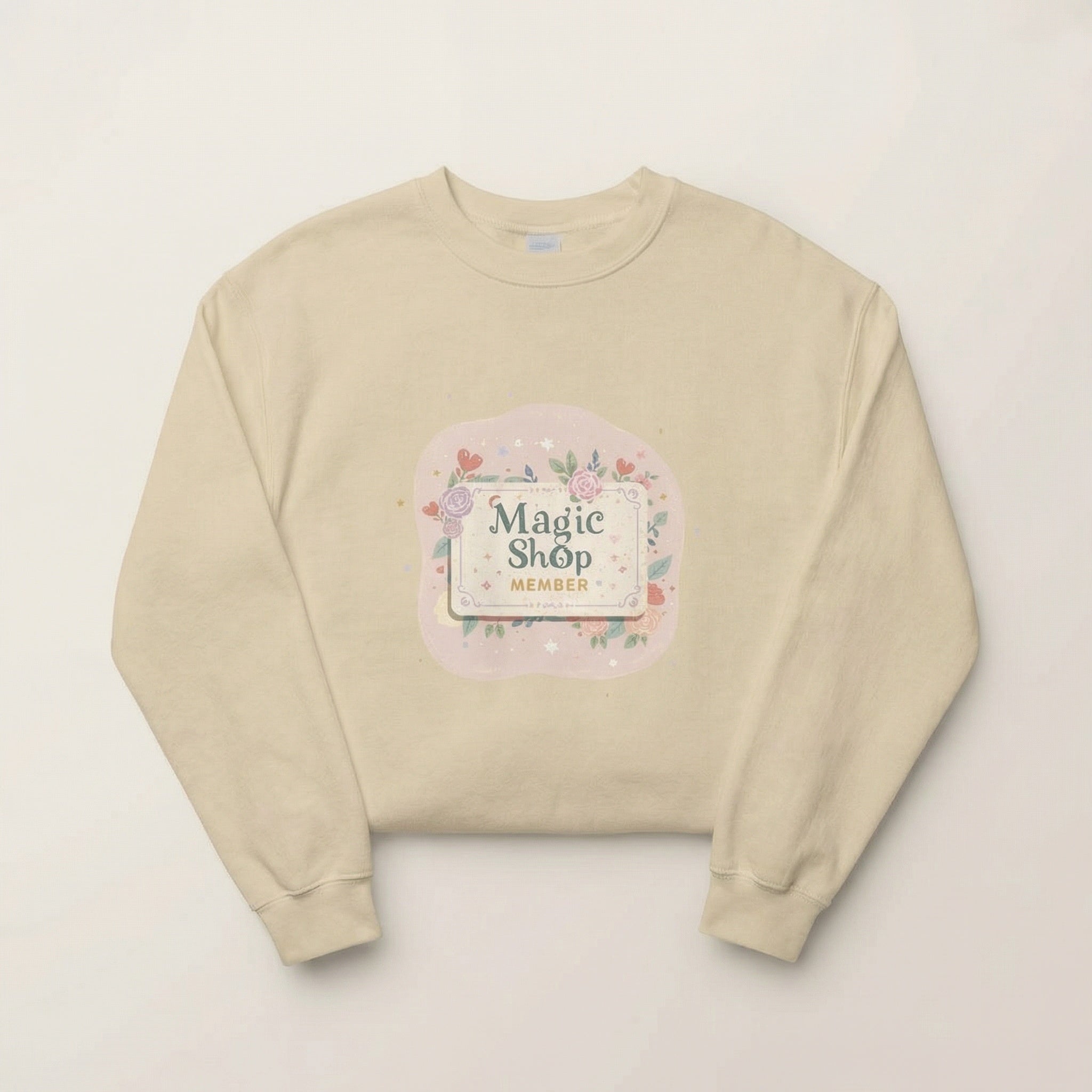 Beige sweatshirt with 'Magic Shop Member' graphic on a light beige background